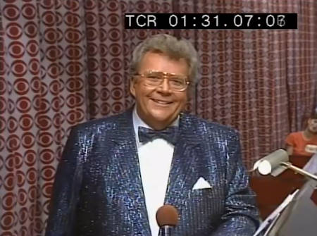 Rod is wearing a black sequined jacket, matching bow tie & white shirt with matching pocket square