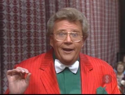 Rod is wearing a red/red-pinstriped jacket, dark-green tuxedo shirt & white bow tie