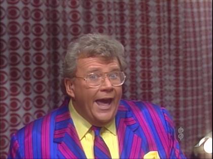 Rod is wearing a blue & purple striped jacket, matching necktie, yellow tuxedo shirt with matching pocket square
