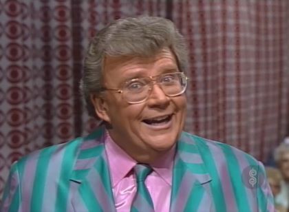 Rod is wearing a green/grey striped jacket, matching necktie & lavender silk shirt