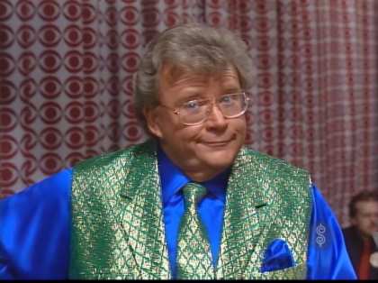 Rod is wearing a shiny green vest, matching necktie, blue silk shirt & matching pocket square