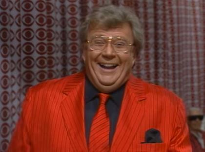 Rod is wearing a red jacket w/black pinstripes, matching tie and a black shirt w/matching pocket square