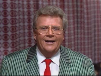 Rod is wearing a green/black/grey pinstriped jacket, white shirt & red necktie