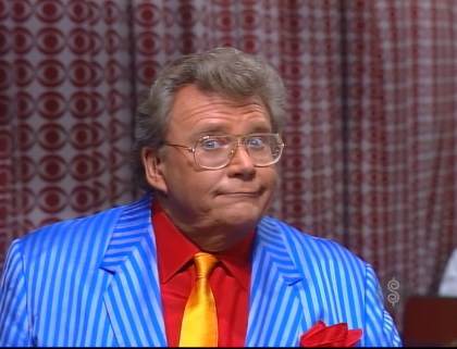 Rod is wearing a blue-blue striped jacket, red shirt, matching pocket square & gold necktie