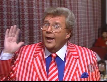 Rod is wearing a red/white striped jacket, matching necktie, blue shirt with white collar & matching pocket square