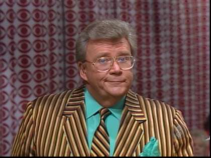 Rod is wearing a brown-black-tan striped jacket, matching necktie and sea-foam green shirt with matching pocket square