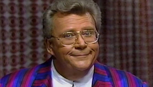 Rod is wearing a blue & fuchsia striped jacket & white collarless silk shirt