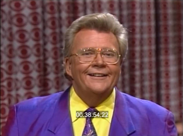 Rod is wearing a purple jacket, matching tie & yellow shirt