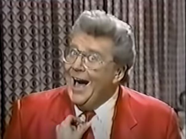 Rod is wearing a red jacket, red tie & white shirt