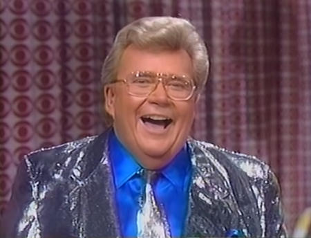 Rod is wearing a shiny silver jacket with matching necktie & blue silk shirt with matching pocket square