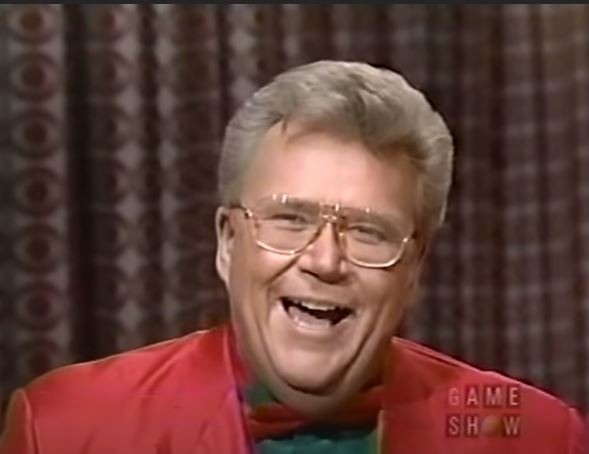 Rod is wearing a red jacket & bow tie with a green shirt