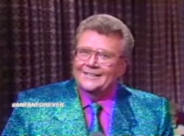 Rod is wearing a blue sequined jacket, matching tie & fuchsia shirt