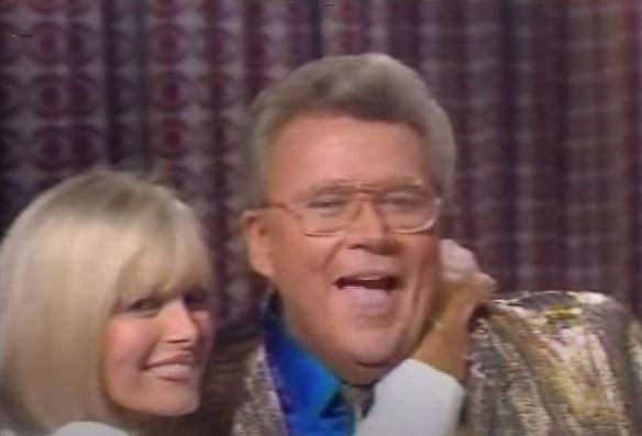 Rod is wearing a gold lamé jacket, matching tie & blue silk shirt