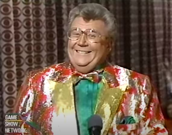 Rod is wearing a red & gold mottled jacket with gold lapels & matching bow tie
with a green silkshirt
