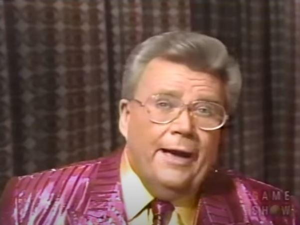 Rod is wearing a shiny pink/pink-striped jacket , matching tie & yellow silk shirt