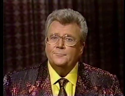 Rod is wearing a brown sequined jacket, matching tie & yellow silk shirt