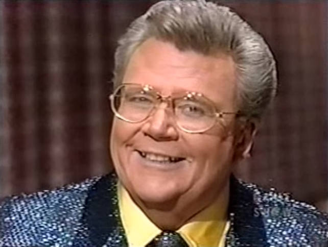 Rod is wearing a Blue-sparkly Jacket & tie w/ a yellow shirt