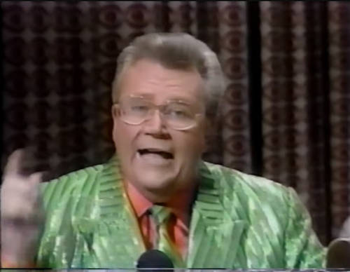 Rod is wearing a shiny green/green striped jacket with matching necktie & salmon-pink collarless silk shirt