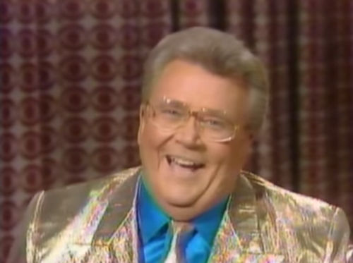 Rod is wearing a Gold iridescent jacket, matching necktie & blue silk shirt