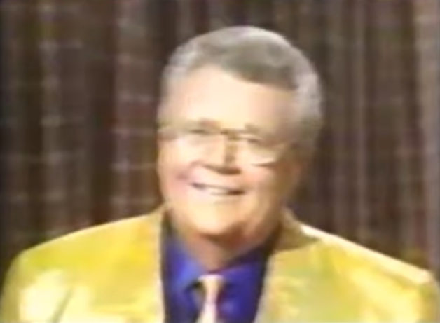Rod is wearing a shiny yellow jacket with matching tie & dark-blue silk shirt