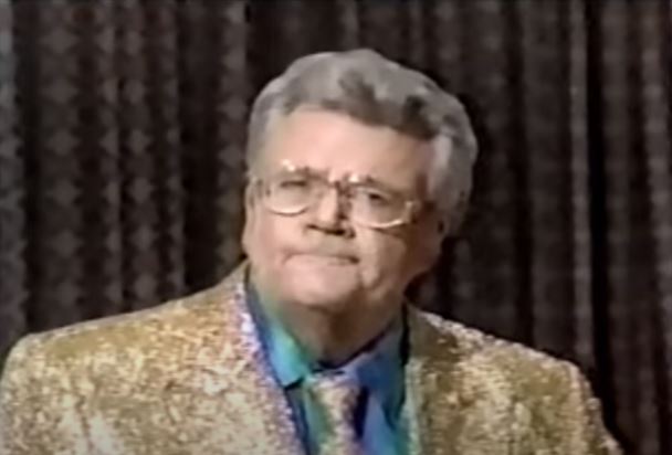 Rod is wearing a gold sequined jacket, matching tie & blue shirt