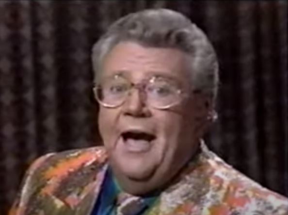 Rod is wearing a gold/orange mottled jacket & tie and a blue silk shirt