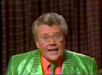 Rod is wearing a shiny green/green-striped jacket with matching neck tie & salmon shirt