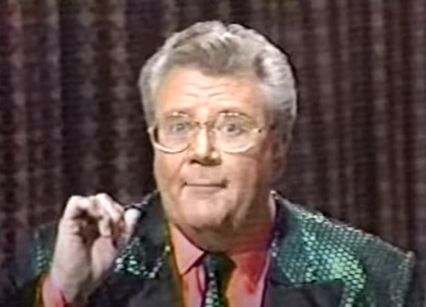 Rod is wearing a shiny green jacket with matching tie & black lapels & salmon shirt