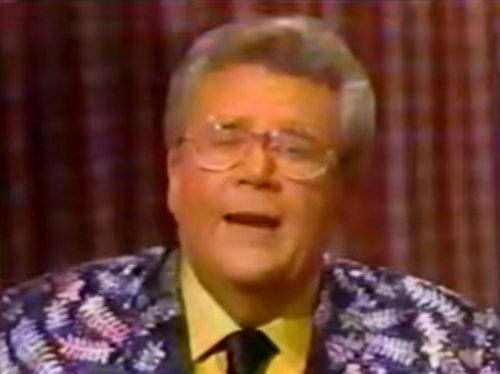 Rod's Jacket is shimmery Purple with silver leaves, purple tie & yellow shirt