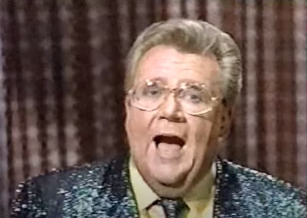 Rod is wearing a dark-green sequined jacket, matching necktie & yellow silk shirt