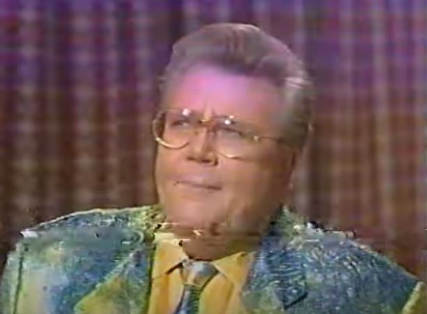 Rod is wearing a yellow & blue patterned jacket, matching tie & yellow shirt