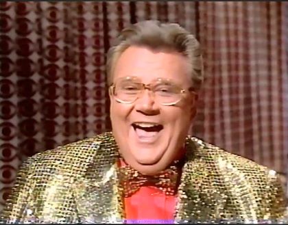 Rod is wearing a gold-sequined jacket, matching bow tie & salmon shirt