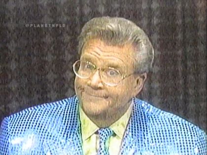 Rod is wearing a blue sequined jacket, matching necktie & yellow silk shirt