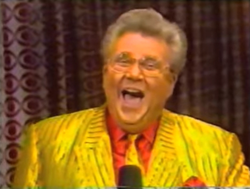 Rod is wearing a shiny yellow/yellow-striped jacket with matching necktie & red silk shirt with matching pocketsquare 