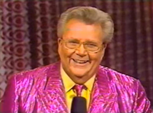 Rod is wearing a shiny pink/pink-striped jacket with matching necktie & yellow shirt