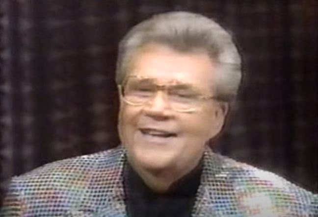 Rod is wearing a rainbow-sequined jacket & black collarless silk shirt