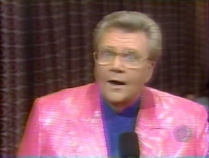 Rod is wearing a shiny pink jacket & dark-blue collarless silk shirt