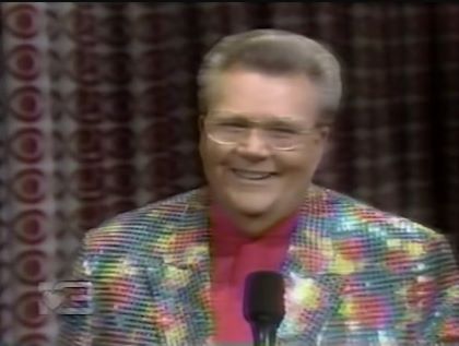 Rod is wearing a multi-colored sequined jacket & fuchsia collarless silk shirt