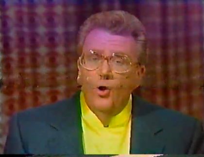 Rod is wearing a dark-green jacket & yellow collarless silk shirt