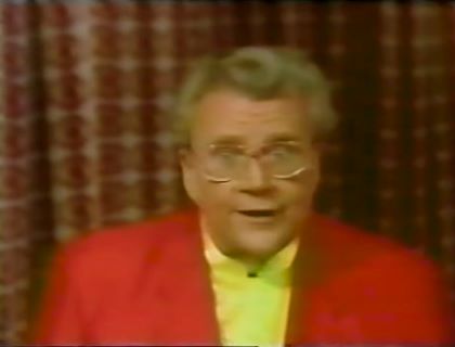 Rod is wearing a red jacket & yellow collarless silk shirt